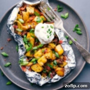 Perfect Foil-Wrapped Potatoes 2 Baked potato foil pack with sour cream and chives, a hearty meal ready to enjoy.
