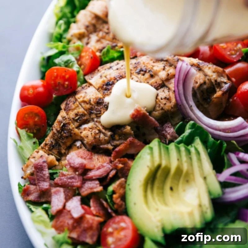 Flavorful Addition: Drizzling Honey Mustard Dressing on Grilled Chicken Finished homemade sauce being poured over grilled chicken, enhancing the dish with delightful flavor.