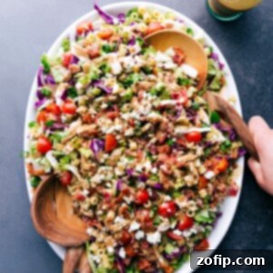 A vibrant bowl of Portillo's Chopped Salad with two serving spoons.