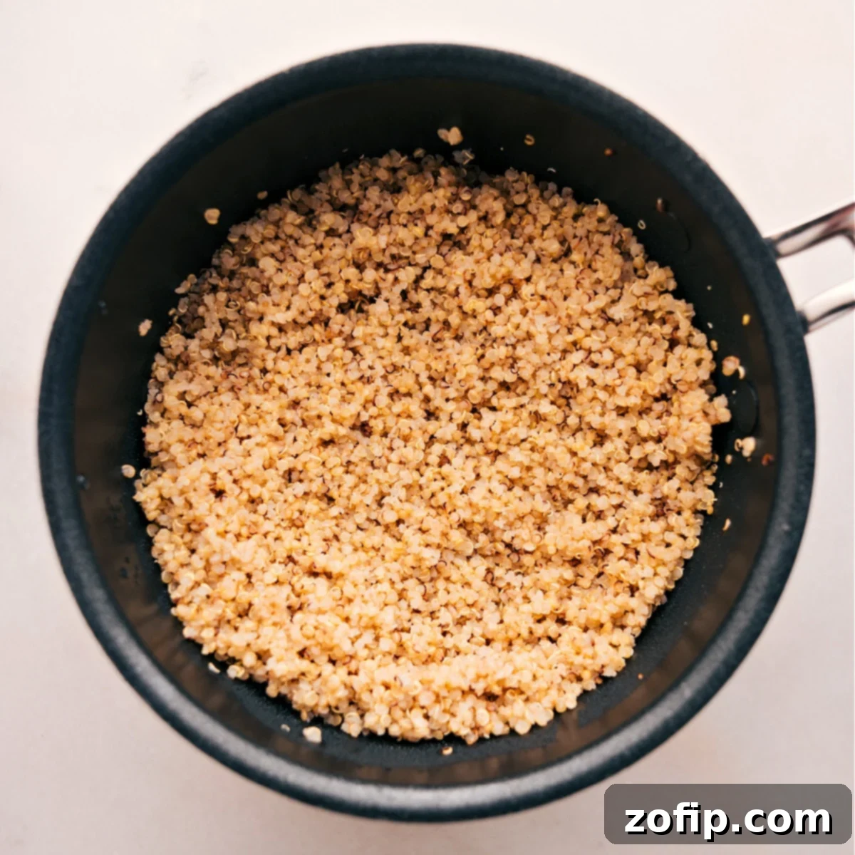 Perfectly Cooked Quinoa: The Ideal Base for Healthy Buddha Bowls Fluffy, perfectly cooked quinoa in a pot, ready to be used as the base for vibrant Buddha bowls.