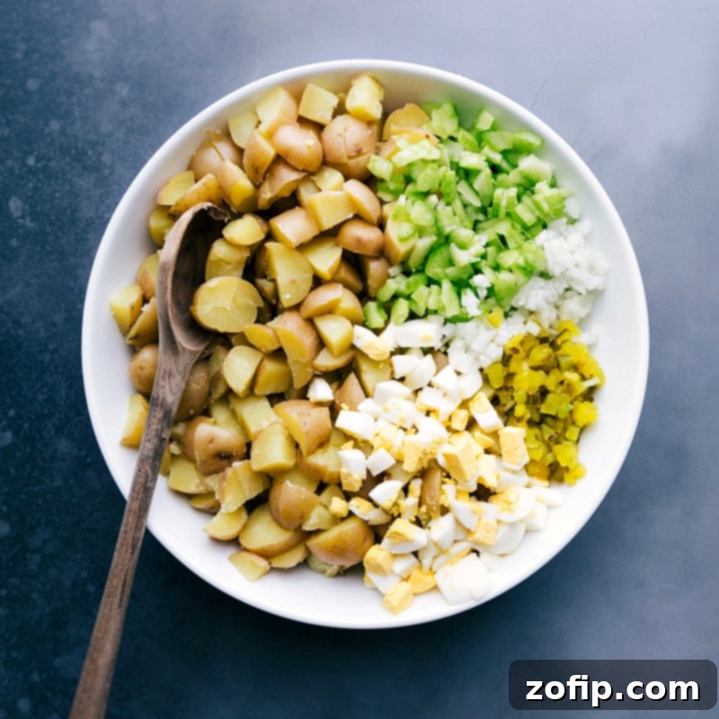 Potato Salad Ingredients: Combining Celery, Onion, Hard-Boiled Eggs, and Pickles Diced celery, onion, hard-boiled eggs, and pickles prepared as additional ingredients for this potato salad recipe.