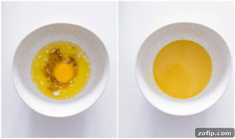 Butter, Vanilla, and Egg Yolk Mixture Process photo of egg yolk, melted butter, and vanilla extract combined for Homemade Cinnamon Rolls.