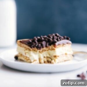 Decadent Eclair Cake 3 A delicious slice of Eclair Cake with a bite taken out, revealing its creamy center.