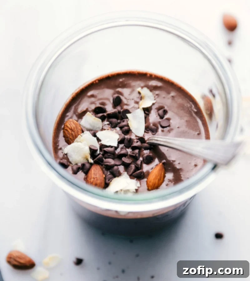 A vibrant and delicious bowl of Almond Joy Overnight Oats, freshly prepared and ready for enjoyment, showcasing its healthy and delightful ingredients including almonds, coconut, and chocolate.