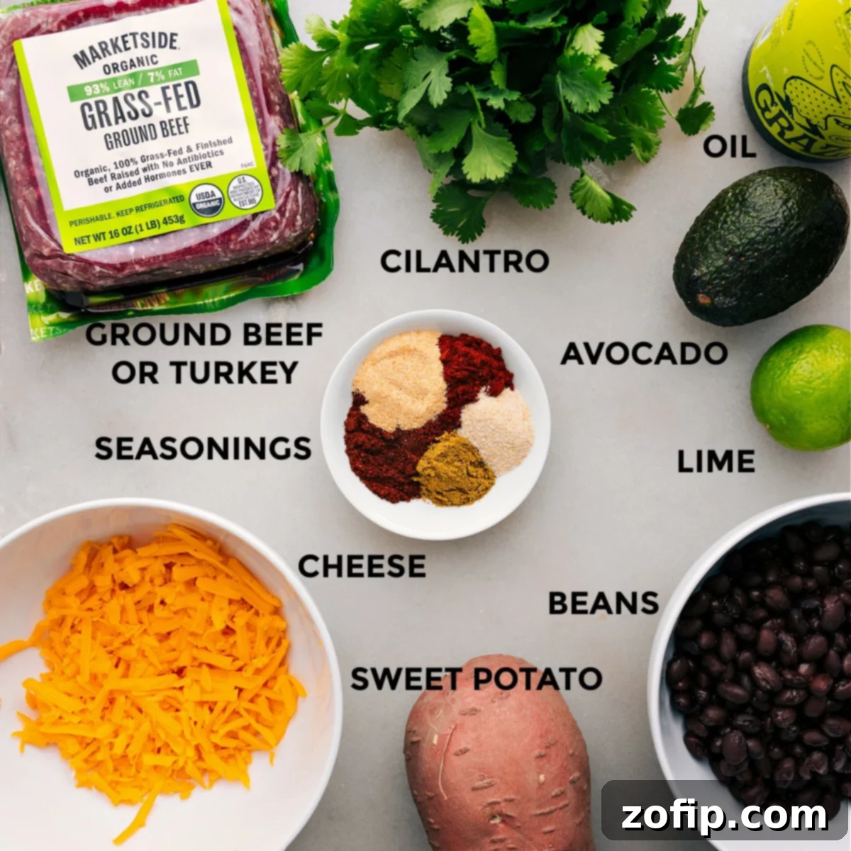 All the fresh ingredients for this recipe are neatly prepped and laid out for easy assembly, including lean ground turkey, diced sweet potatoes, black beans, shredded cheese, and vibrant cilantro.