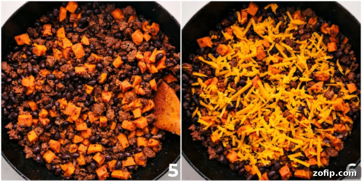 The final step of the Ground Turkey Sweet Potato Skillet, with cheese melting on top, garnished beautifully with fresh avocado, cilantro, and a lime wedge, ready to be served.