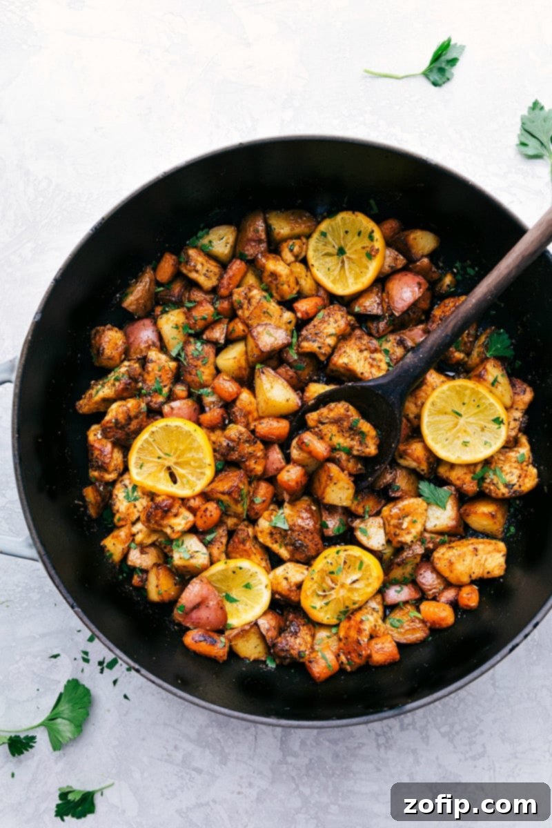A healthy, fresh, and flavorful one-skillet meal featuring lemon chicken, red potatoes, and carrots. Delicious One-Skillet Lemon Chicken and Potatoes with fresh lemon slices and parsley