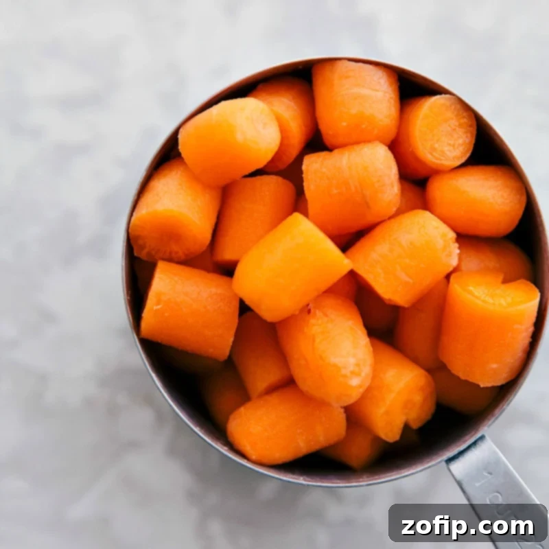 This Greek-inspired Lemon Chicken and Potatoes meal can be ready in 30 minutes or less, highlighting quick prep. Freshly chopped carrots in a measuring cup, ready for a one-skillet meal