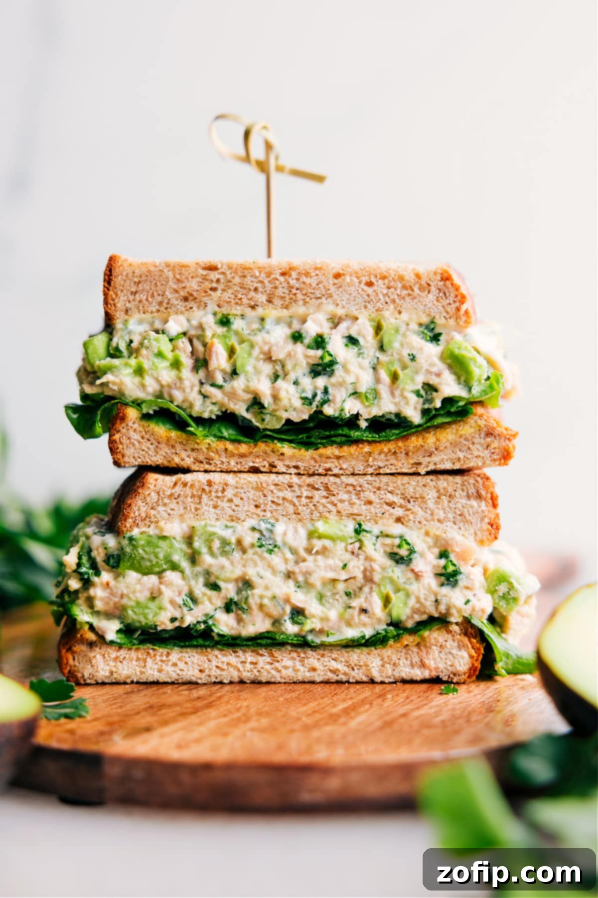 Delicious Avocado Tuna Salad sandwich, cut in half and stacked, ready to enjoy as a healthy, quick lunch.