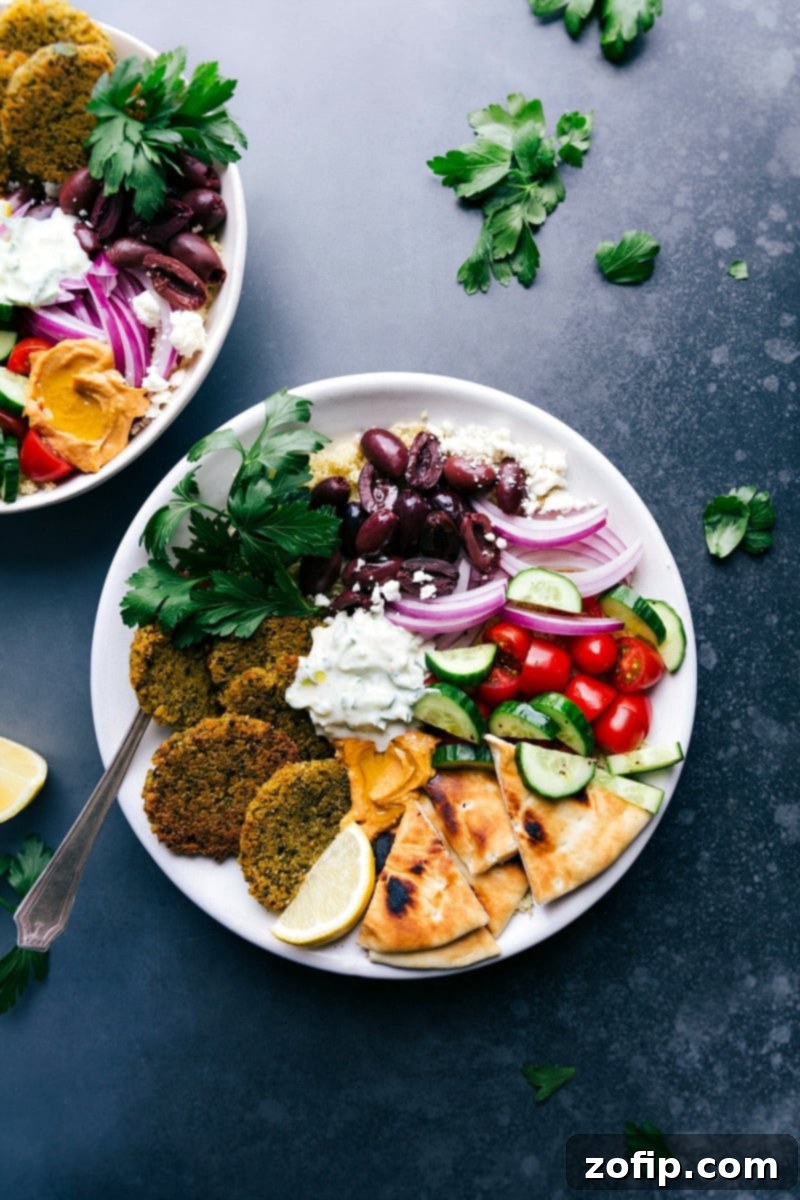 Plate of Baked Falafel with Pita Bread, Tzatziki Sauce, Olives, Onions, Tomatoes, and Cucumbers Baked falafel served on a plate with pita bread, tzatziki sauce, olives, onions, tomatoes, and cucumbers.