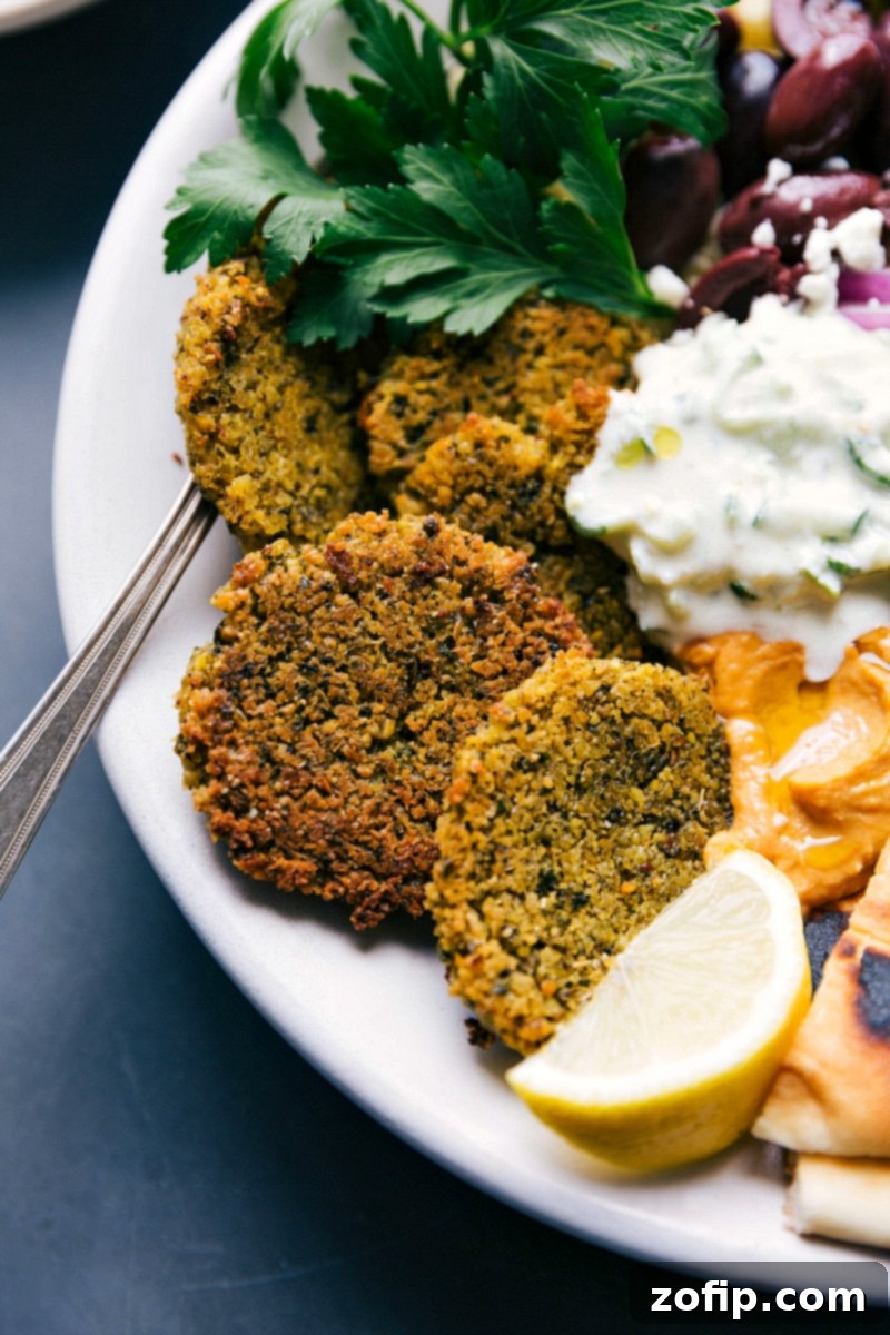 Finished Meal: Baked Falafel with Tzatziki Sauce and Sides, Ready for Enjoyment The completed meal with tzatziki sauce, and finished side dishes, ready to be enjoyed.