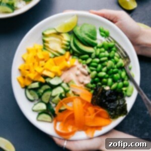 Deconstructed Sushi Bowls 4 Vegetarian sushi bowl with all the ingredients arranged together and the sauce in the middle.