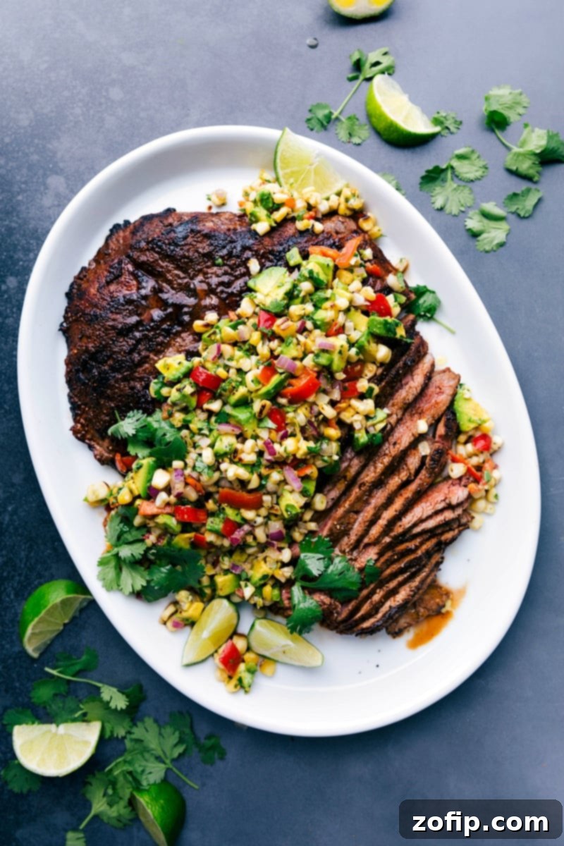 Sliced flank steak with corn salsa showing the perfectly cooked interior, creating a deliciously complimentary meal.