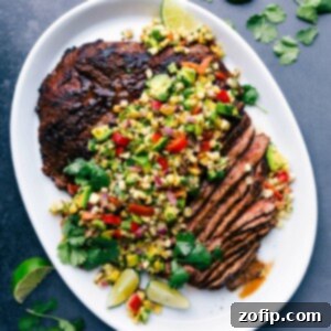 Sliced flank steak with corn salsa showing the perfectly cooked interior, creating a deliciously complimentary meal.