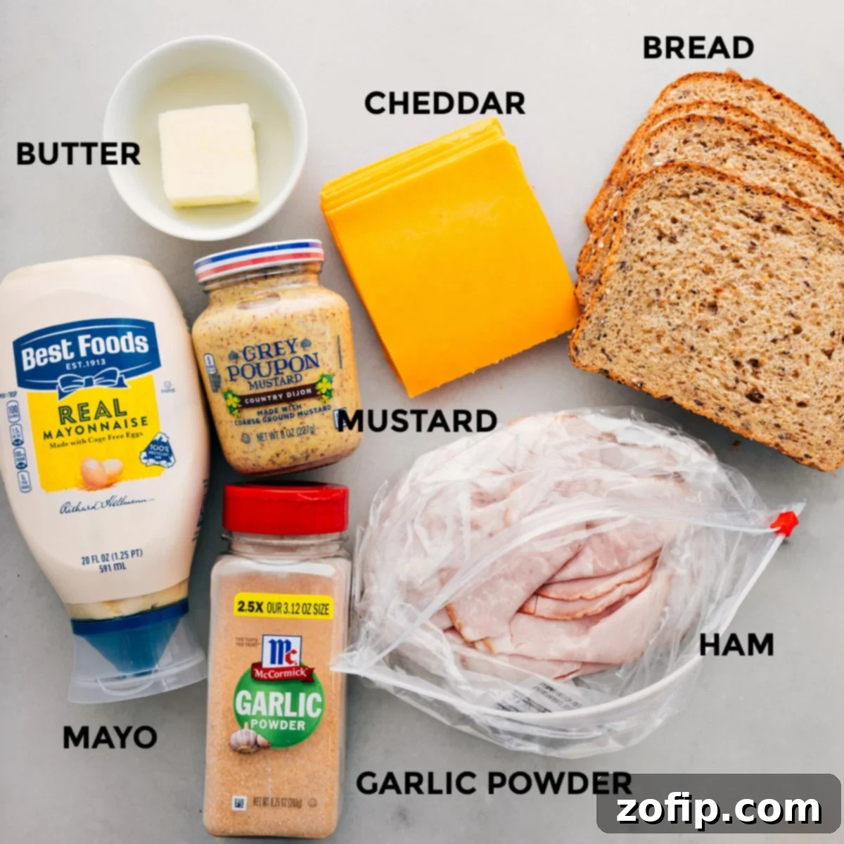 Golden Ham and Cheese Treat 4 All the fresh ingredients for a ham and cheese sandwich: whole grain bread, butter, sharp cheddar cheese, deli ham, mayo, country mustard, salt, and garlic powder.