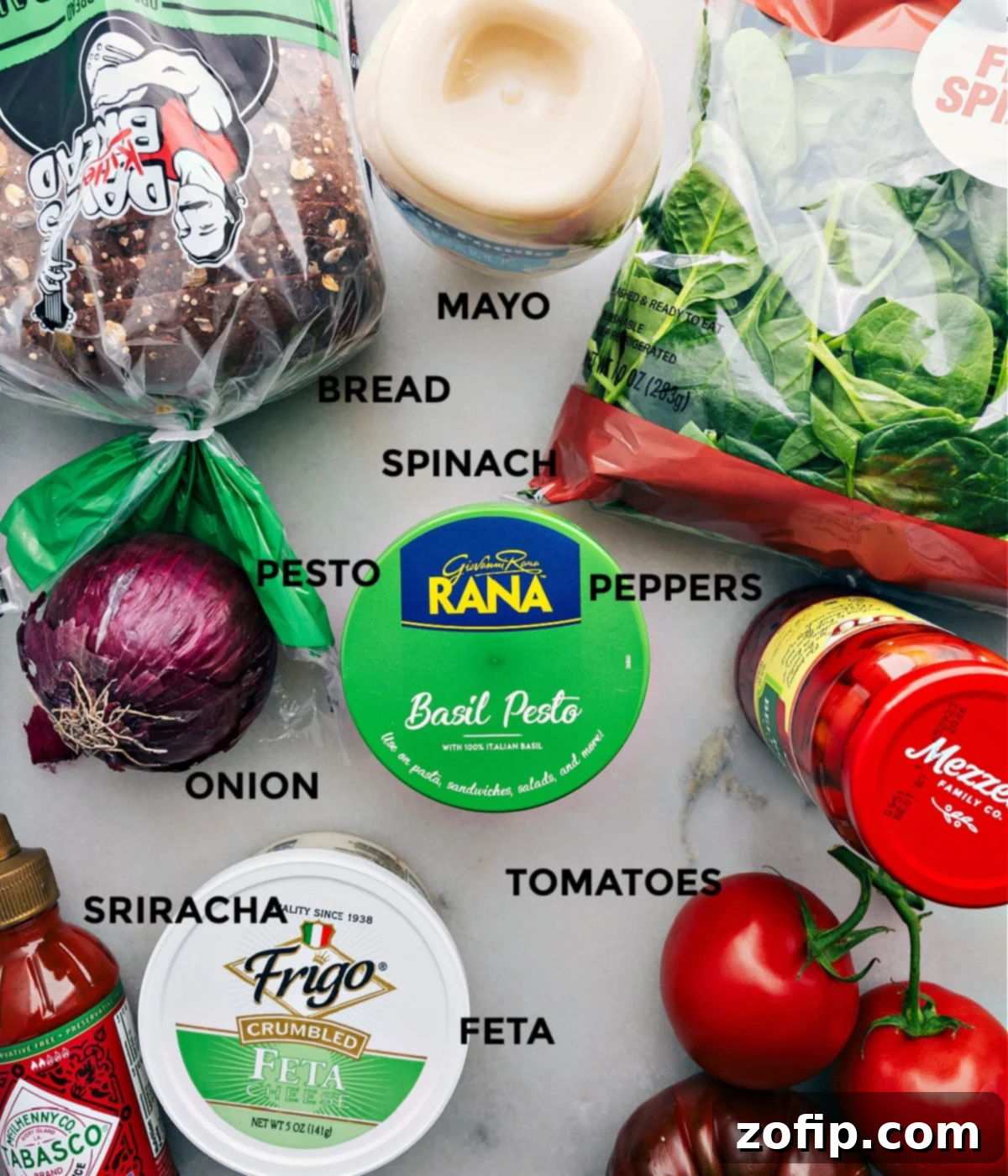 All the vibrant, fresh ingredients in this Mediterranean sandwich recipe, meticulously prepped and laid out for easy assembly.