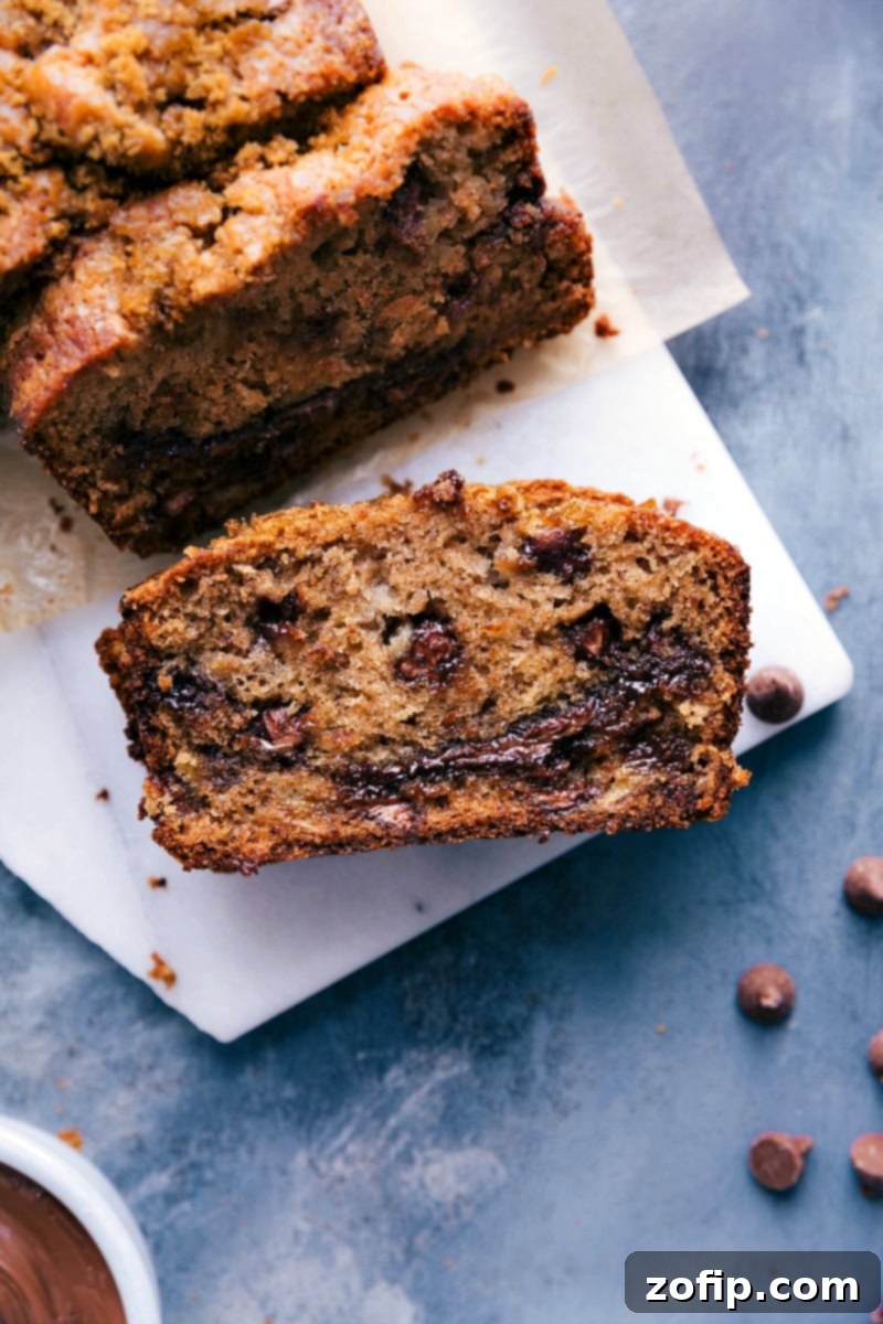 Super-moist banana bread swirled with Nutella and chocolate chips. Nutella Banana Bread is my all-time favorite sweet bread; it's flavorful and loaded with chocolate! Recipe via ChelseasMessyApron #breakfast #dessert #quick #easy #simple #best #chocolate #nutella #banana #bread #bananabread