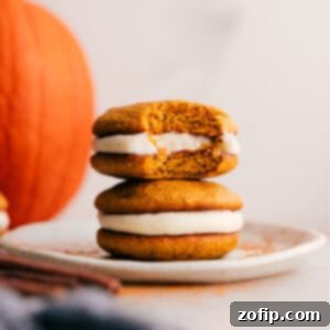 Irresistible Pumpkin Whoopie Pies 3 Close-up of a stack of Pumpkin Whoopie Pies with creamy filling, garnished with cinnamon, representing a perfect fall dessert.
