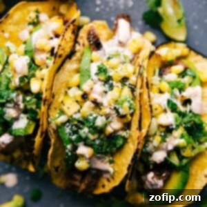 Finished steak taco recipe, with tacos side by side, stuffed with delicious meat, corn salsa, and various toppings.