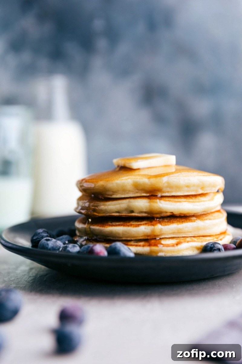 Enjoy these nutritious and protein-packed Greek Yogurt Pancakes for breakfast! A beautiful stack of golden Greek Yogurt Pancakes, ready to be served.