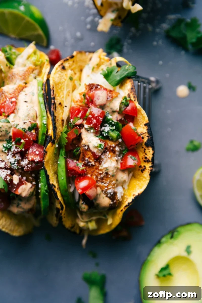 Fish Tacos - A Flavorful Delight Two vibrant fish tacos bursting with fresh ingredients and creamy sauce, ready to be enjoyed.