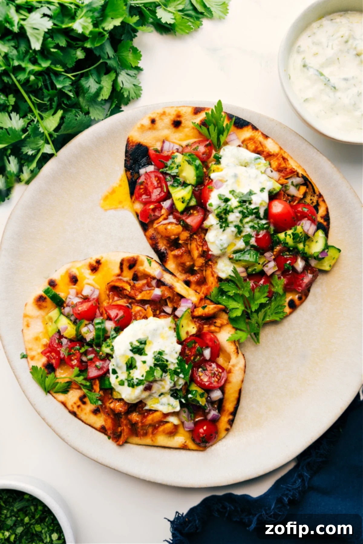 Delicious Chicken Shawarma Wraps on charred naan with fresh vegetables and creamy sauce, ready to eat and enjoy.