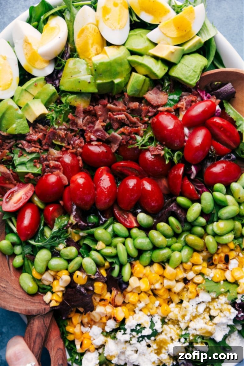Overhead view of a meticulously arranged Cobb Salad, bursting with color and fresh ingredients, ready to be served.