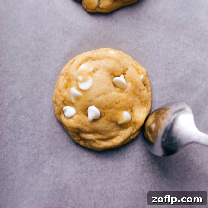 A freshly baked cornmeal cookie, rounded by using the back of a spoon while still warm, ready to be enjoyed as a delicious treat.