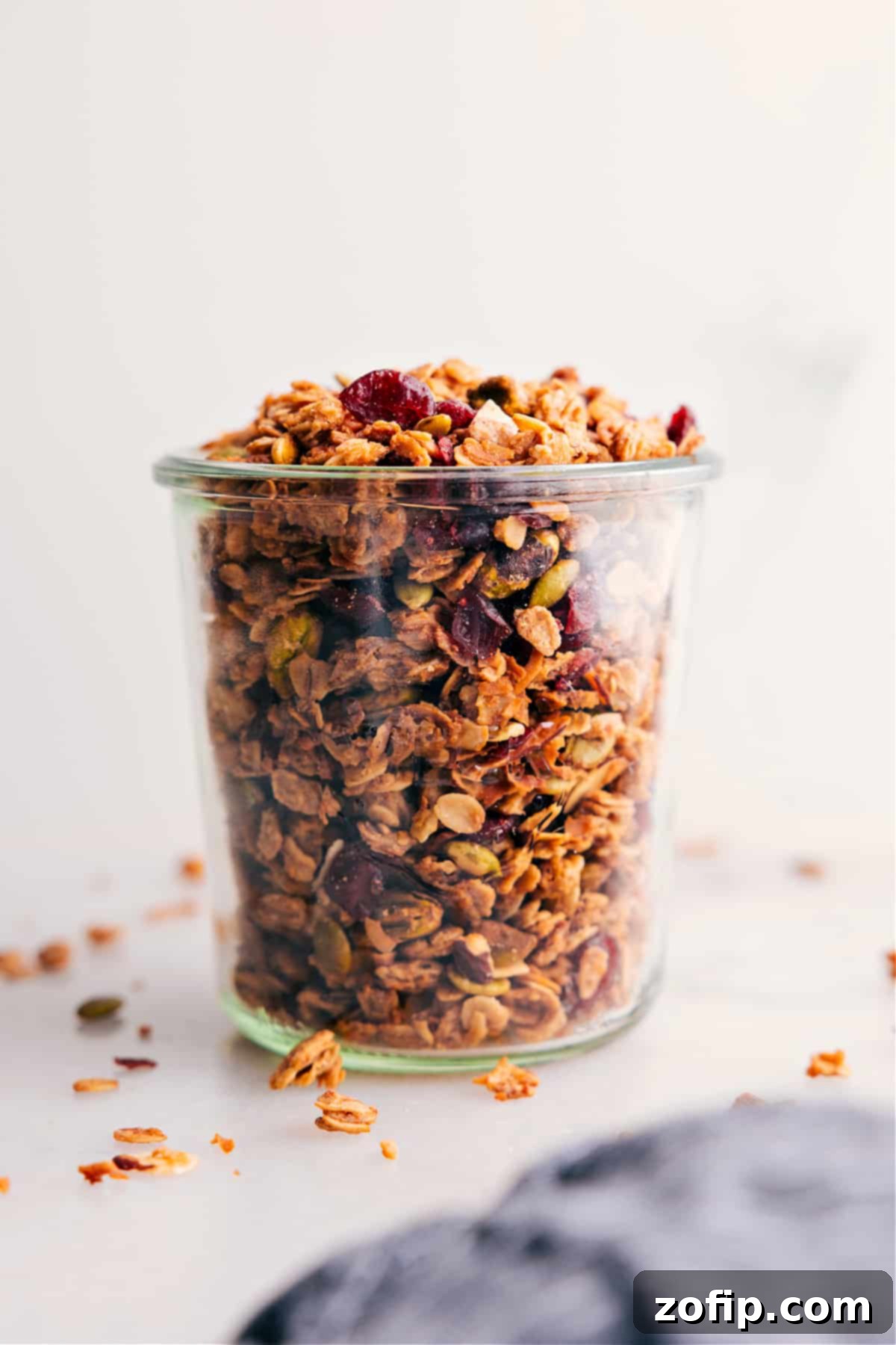 Delicious homemade granola stored in a clear glass jar, ready for easy access.