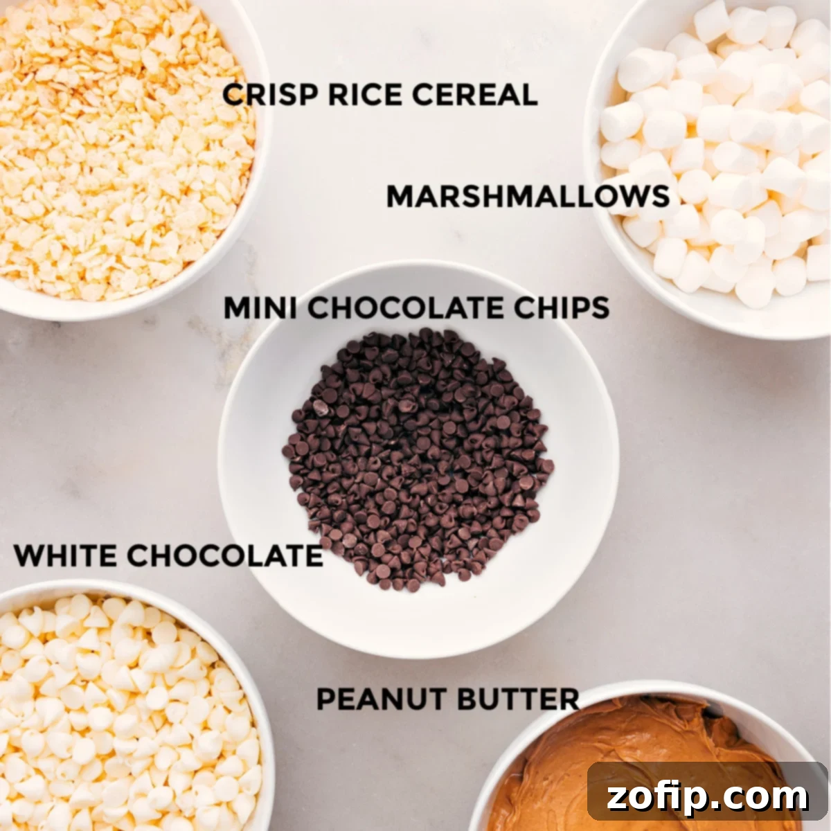 Key Ingredients For Avalanche Cookies All essential ingredients for Avalanche Cookies are neatly arranged and ready for preparation: mini marshmallows, chocolate chips, high-quality white chocolate, creamy peanut butter, and crispy rice cereal.