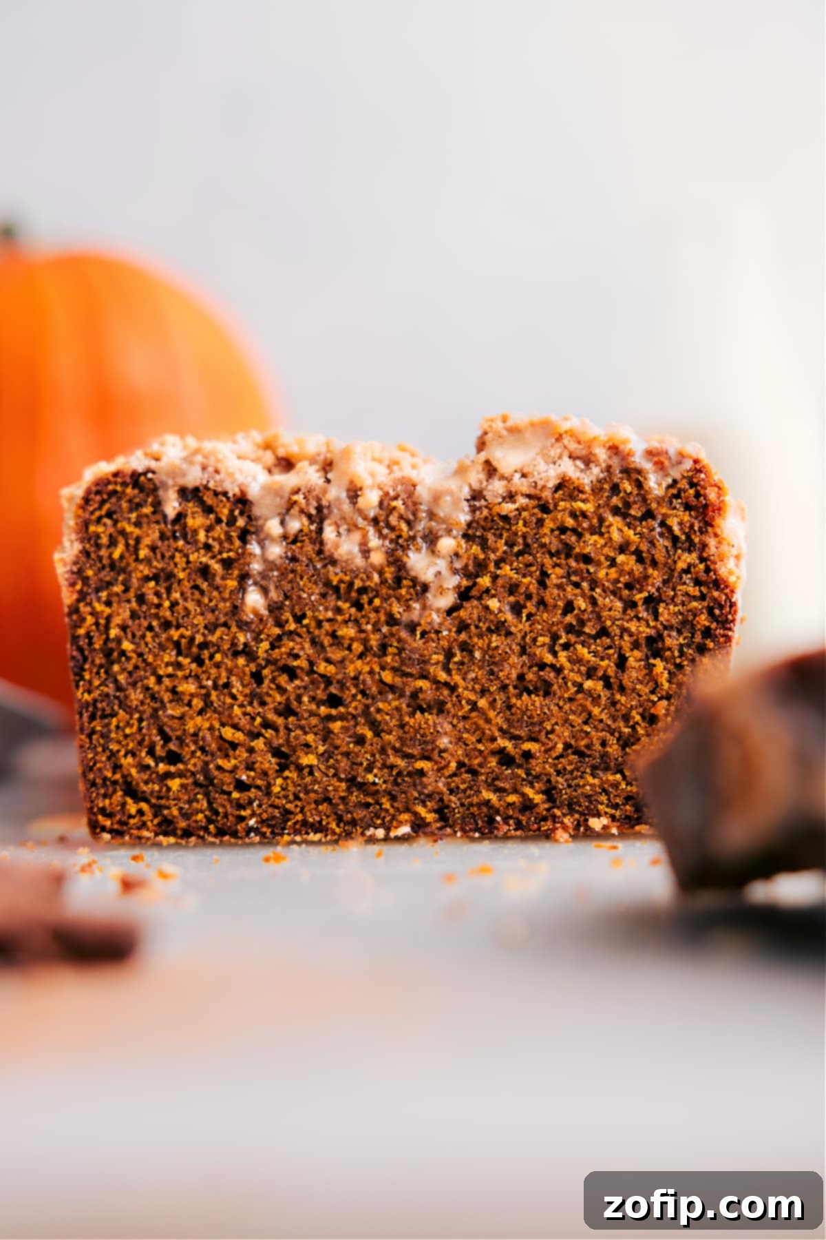Pumpkin Bread with Streusel Topping - A Slice of Autumn Delight A perfectly sliced loaf of Pumpkin Bread with Streusel Topping, revealing its moist texture and golden crumbs.