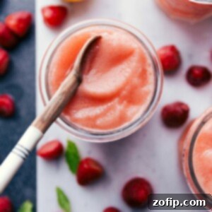 Refreshing lemon berry slush in a glass with a spoon, ready to enjoy.