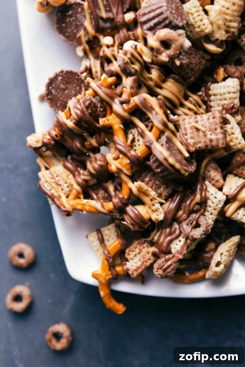 A beautifully presented platter of the finished Chocolate Peanut Butter Snack Mix, broken into enjoyable pieces, ready for guests or a delightful personal treat.