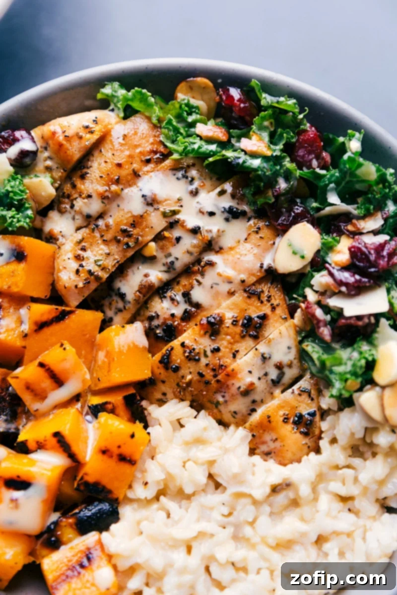 Up-close overhead image of the Harvest Bowl with dressing generously drizzled over it, highlighting all the ingredients.