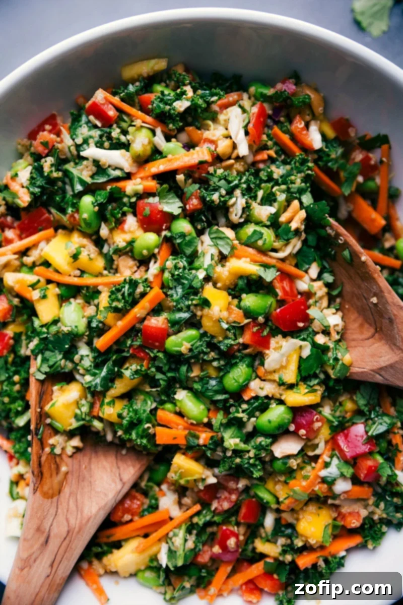 A vibrant bowl of Thai quinoa salad, showcasing a colorful mix of quinoa, fresh vegetables, mango, and herbs, ready to be enjoyed.