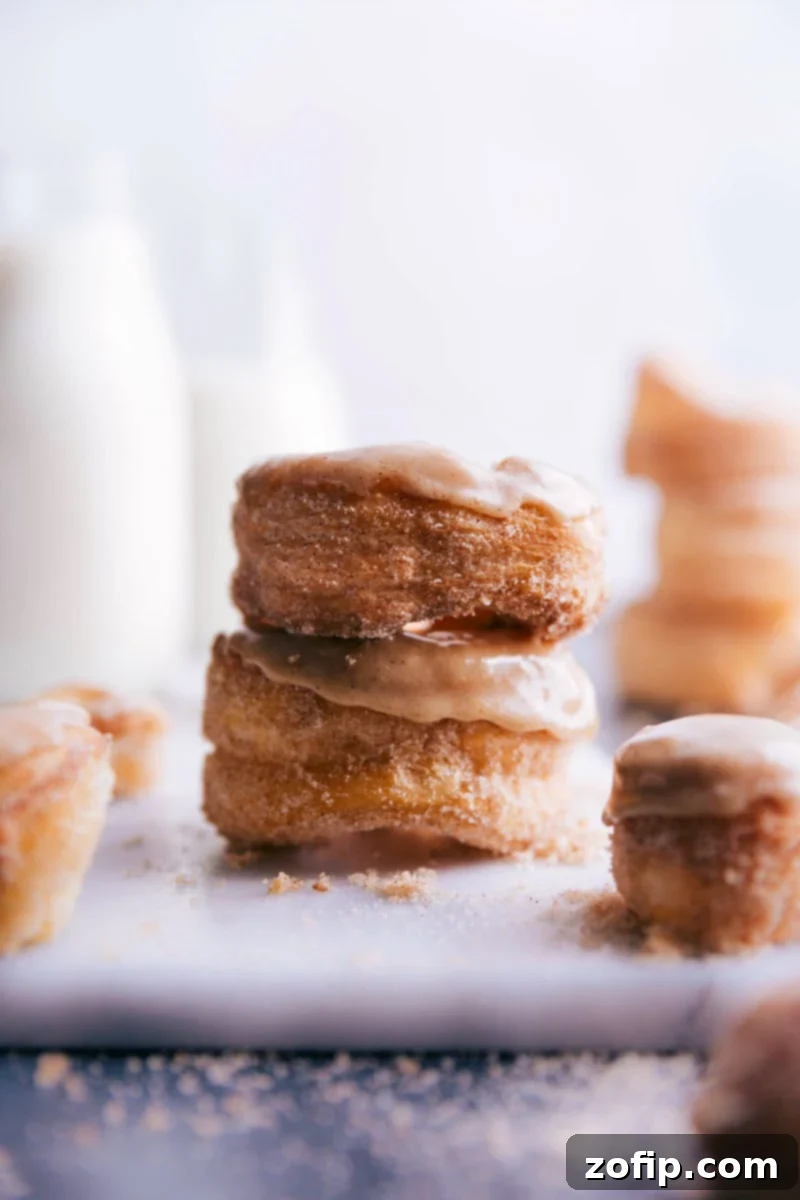 Stack of golden-glazed cronuts, showcasing their exquisite flaky layers and tempting sweetness.