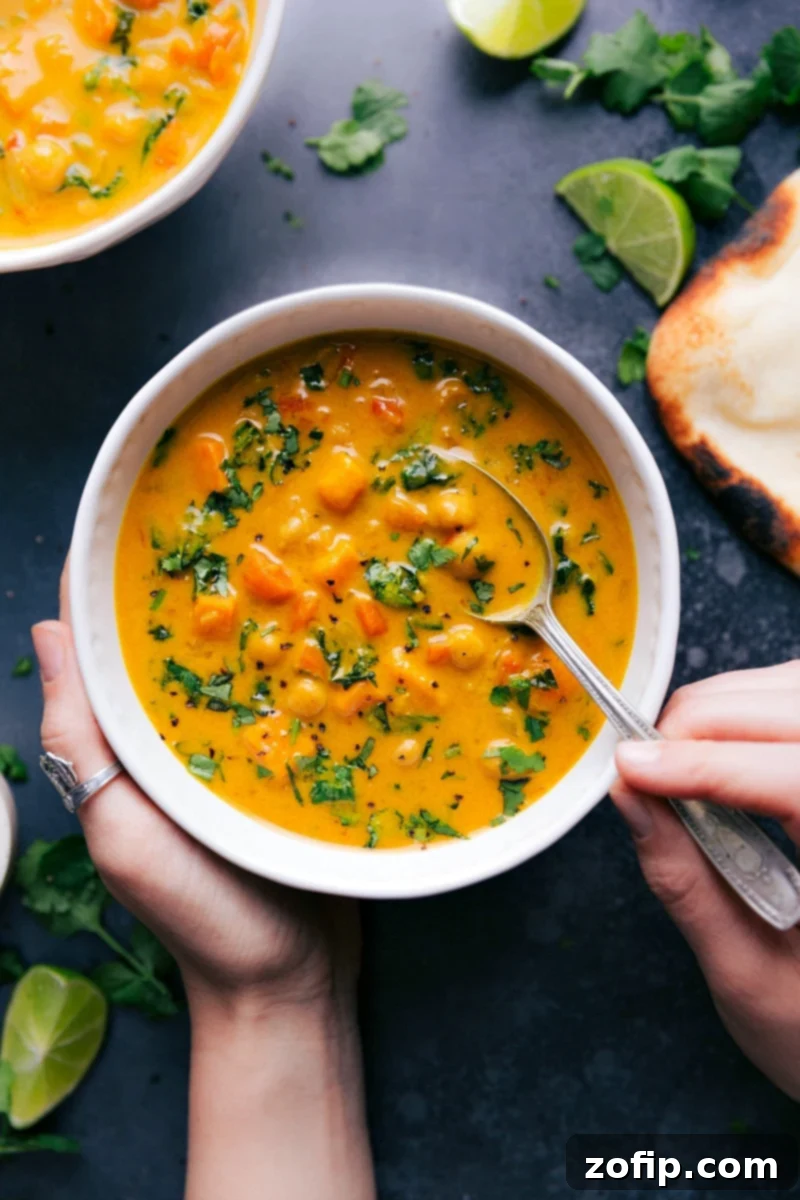 Warm Bowl of Sweet Potato Coconut Curry Soup Packed with Flavor and Nutrients A beautifully presented bowl of warm sweet potato coconut curry soup, garnished with fresh herbs and a swirl of coconut cream, exuding rich flavors.