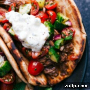 Beautifully plated Beef Gyro with all its components, ready to be enjoyed.