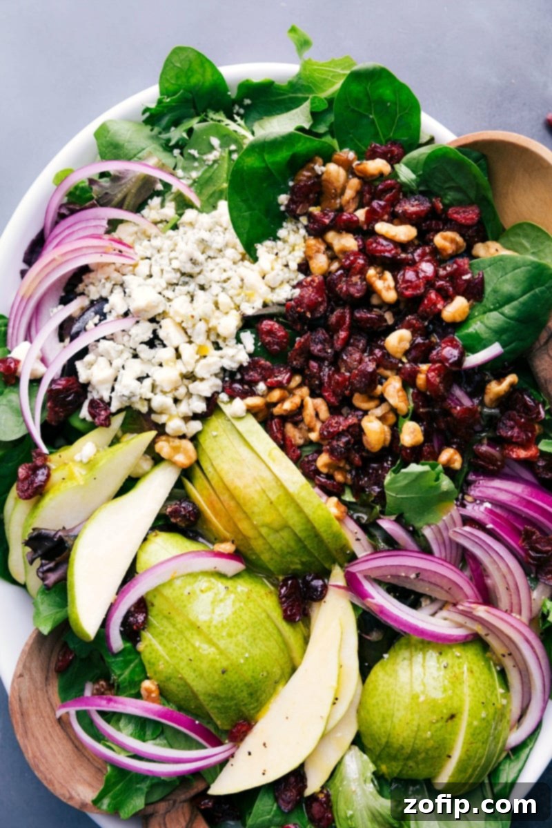 Freshly prepared pear salad beautifully arranged on a white platter, ready for guests to enjoy.