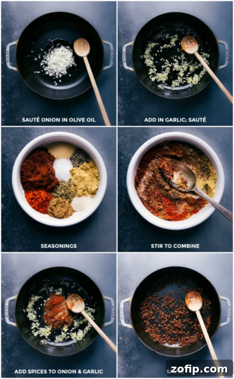 Close-up of a pan on the stovetop, where diced yellow onions and minced garlic are being sautéed in olive oil until translucent and fragrant, forming the flavor base for the chicken taco filling.