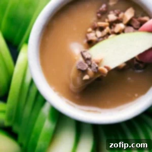 A close-up image of a luscious bowl of homemade caramel sauce, rich and golden, invitingly smooth and ready to be used as a delicious topping or dip.