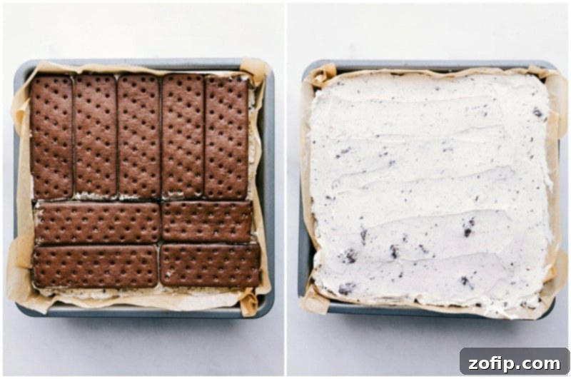 Ice Cream Sandwich Dream 6 The final layers of the ice cream sandwich cake being assembled in a pan, with a smooth layer of whipped topping applied and crushed Oreos being sprinkled on top.