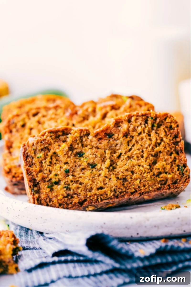Perfectly baked, moist, and delicious slices of Healthy Zucchini Bread. Slices of healthy zucchini bread on a plate, ready to be served