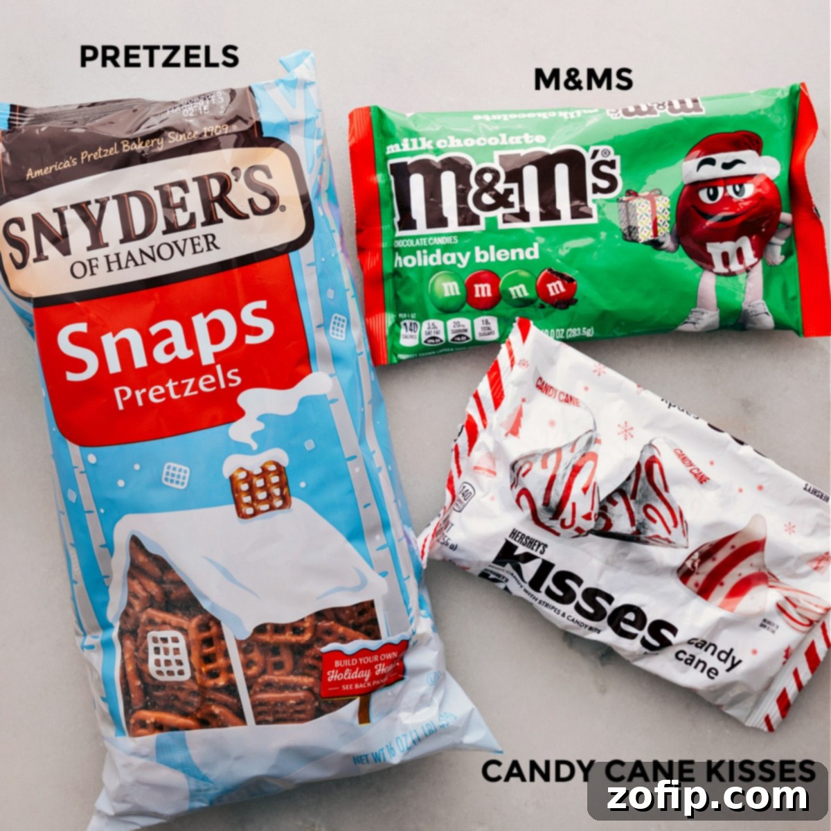 Simple Three-Ingredient Peppermint Bark Pretzels Recipe The three essential ingredients – pretzels, M&Ms, and peppermint chocolate kisses – are neatly arranged, showcasing the simplicity of this holiday treat recipe.