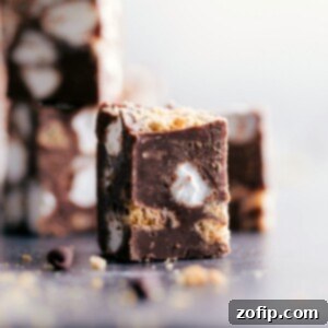 Toasted Marshmallow Chocolate Fudge 2 A square piece of S'mores Fudge, showcasing its rich chocolate, graham cracker, and marshmallow layers.