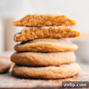 Delicious brown sugar cookies stacked with one broken to show texture.