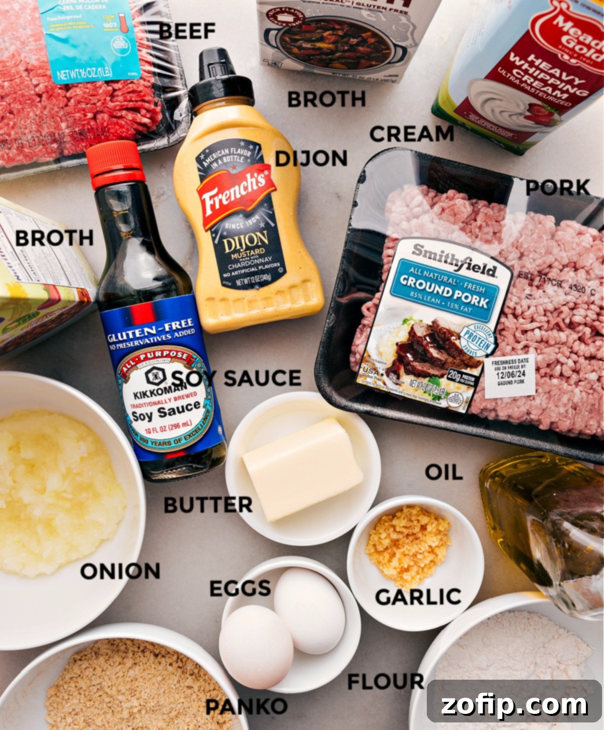 Key Ingredients for The Best Swedish Meatballs Recipe Ingredients for Swedish Meatballs arranged: ground pork, heavy cream, Dijon mustard, soy sauce, butter, oil, onions, ground beef, panko breadcrumbs, eggs, flour, and beef broth.