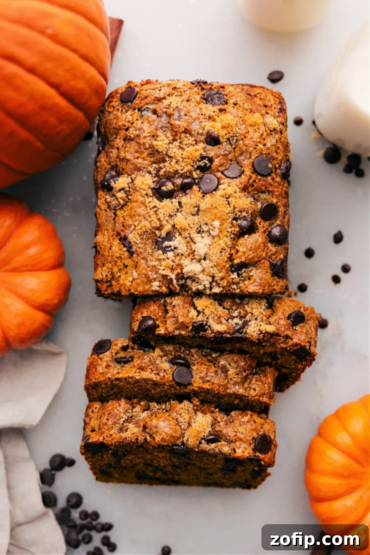 A loaf of moist pumpkin bread with a rich orange color, sliced and ready to enjoy.
