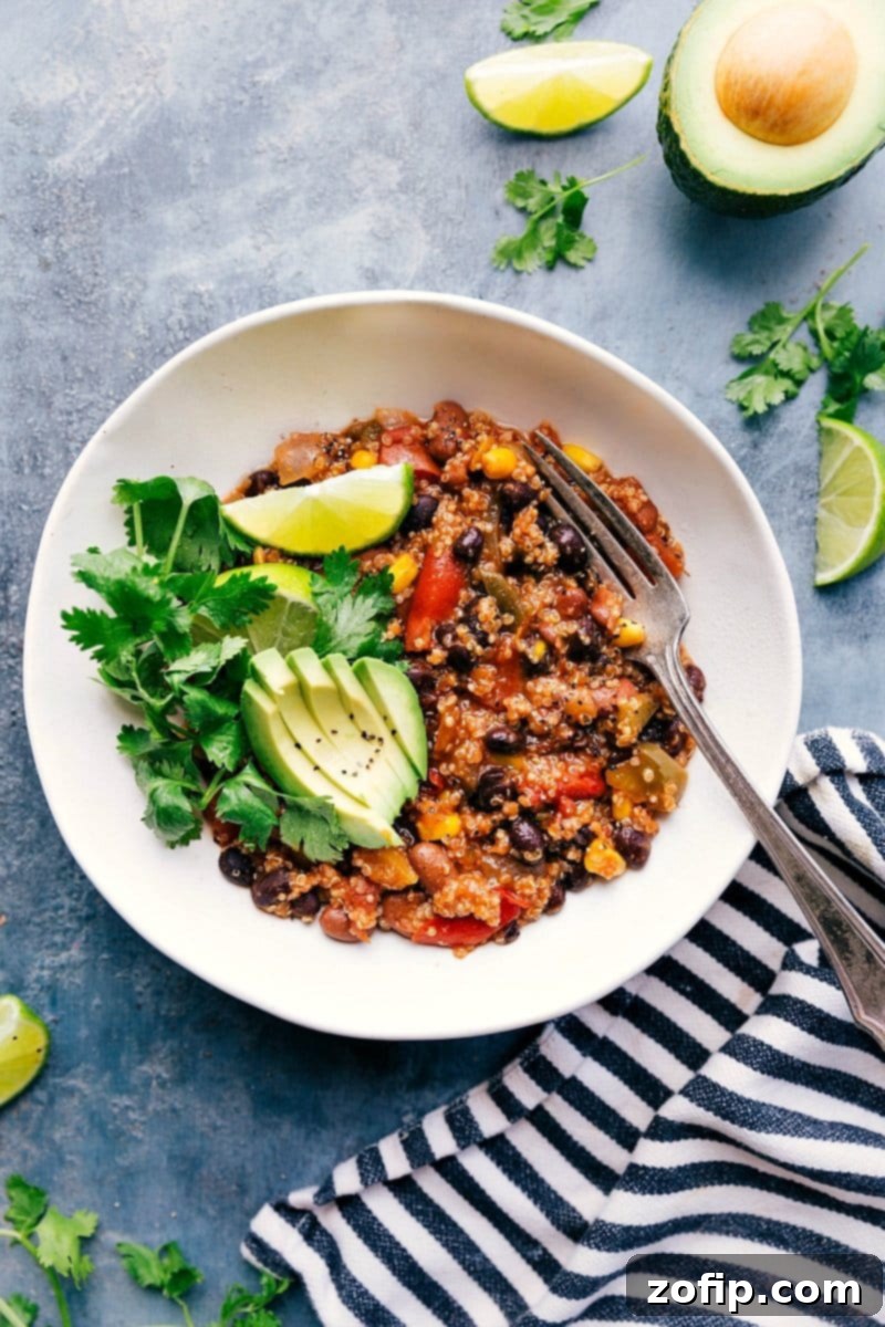 Delicious Crockpot Quinoa with vibrant fajita-inspired flavors, generously topped with creamy avocado slices and fresh cilantro.