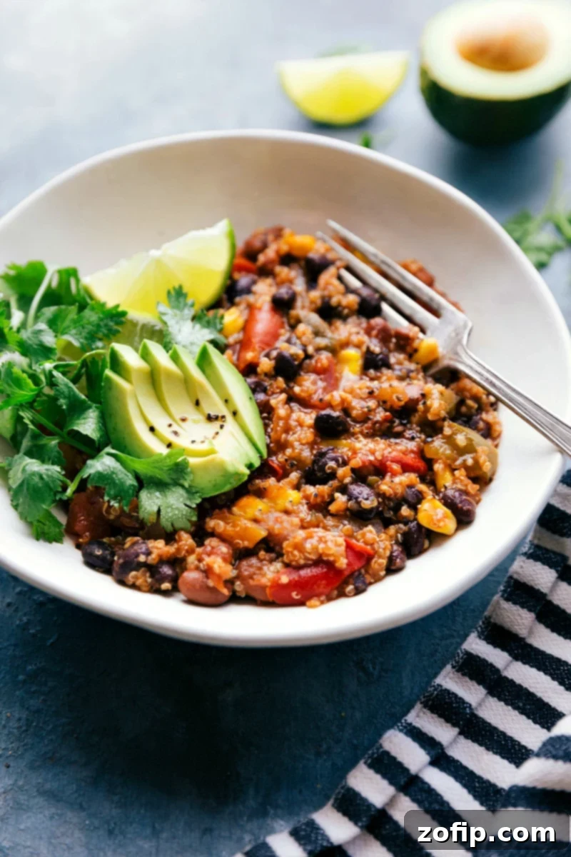 A beautifully presented bowl of the completed Crockpot Quinoa dish, garnished with fresh avocado slices and cilantro, ready to be thoroughly enjoyed.